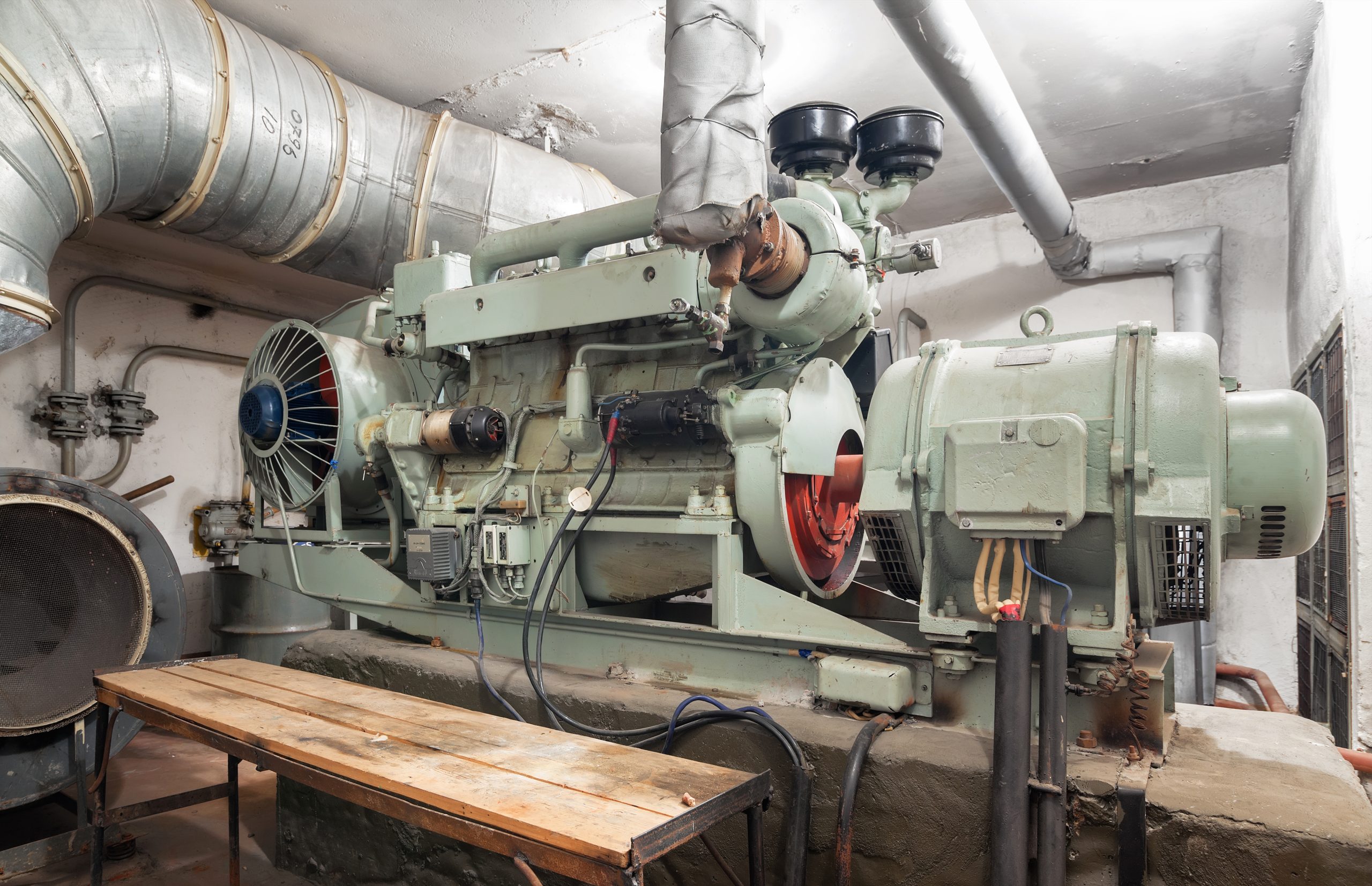 Large green generator in a basement